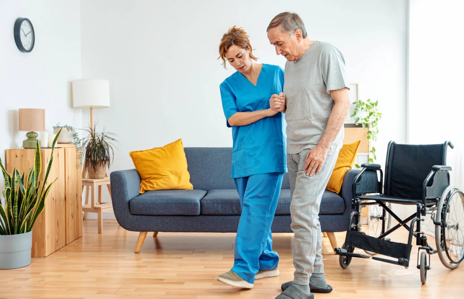 Caregiver helping an older adult walk at home